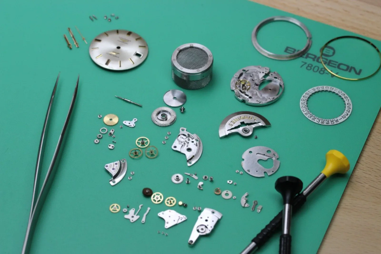 Movement taken apart on a watchmaker’s mat, authenticity checked part by part